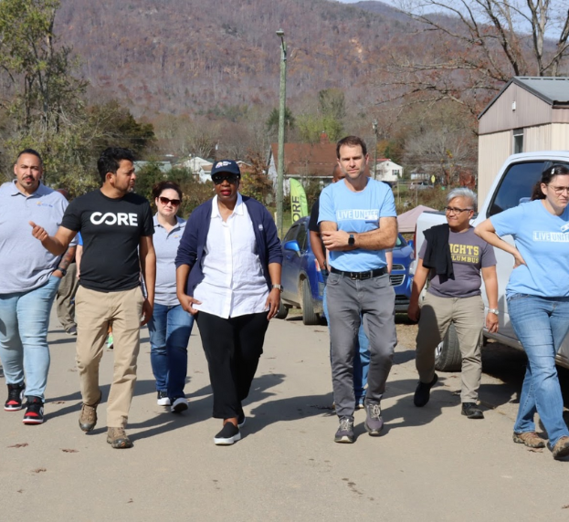 Angela Williams walks beside Antonio Garcia (CORE) and Dan Leroy (UWABC) along with others in Swannanoa, NC