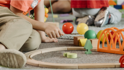 child play with train tracks and balls